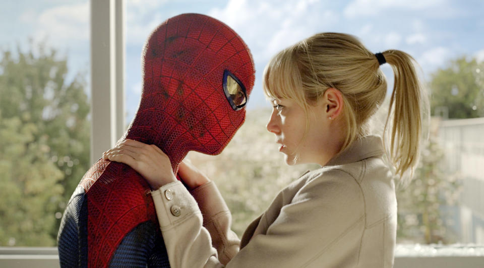 Gwen looks deeply into Spider-Man's eyes through his mask