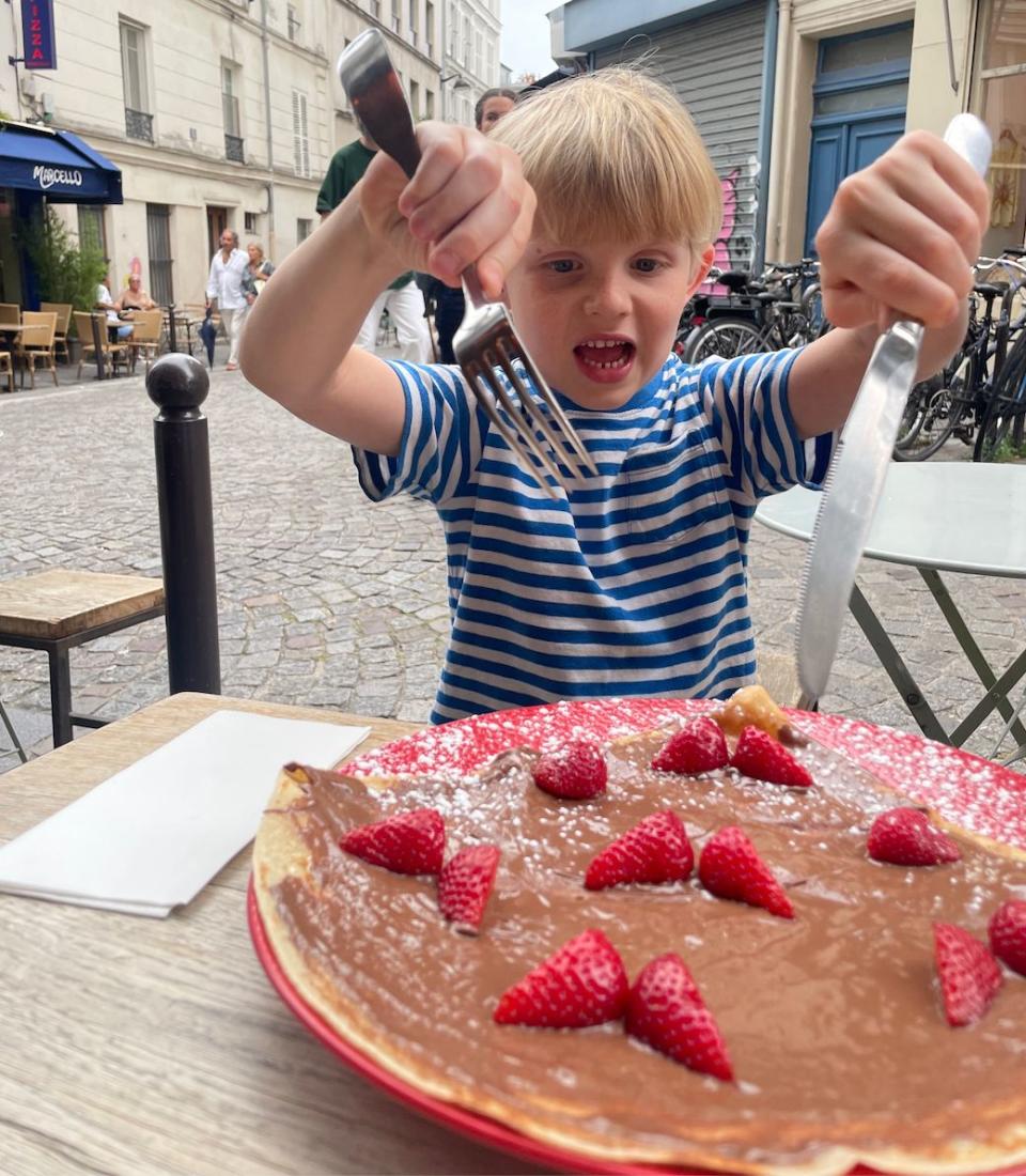 The author's son eating a crepe