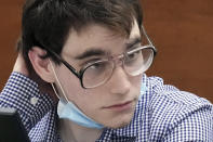 FILE- Nikolas Cruz sits at the defense table during the third day of preliminary jury screening in the penalty phase of his trial, on April 6, 2022, at the Broward County Courthouse in Fort Lauderdale, Fla. The 12 jurors and 10 alternates chosen this past week to decide whether Cruz is executed will be exposed to horrific images and emotional testimony, but must deal with any mental anguish alone. (Amy Beth Bennett/South Florida Sun-Sentinel via AP, Pool, File)