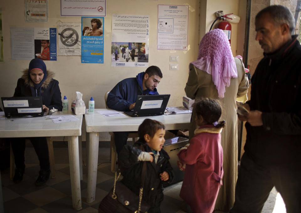 This Wednesday, Dec. 18, 2013 photo shows Syrian women checking in at the U.N. refugee agency's registration center in Zahleh, in Lebanon's Bekaa Valley. For many Syrians fleeing the bloody fighting, the anguish over their wrecked lives only deepens once they arrive in neighboring Lebanon, starting their lives as refugees. Fear, confusion and poor information flows means many Syrians who are in most need of help don't know where to turn to for assistance. With the endless surge of refugees, coupled with what is forecast to be a bitter winter, humanitarian organizations are struggling to find ways to reach refugees with the timely, accurate information they need to survive. (AP Photo/Maya Alleruzzo)