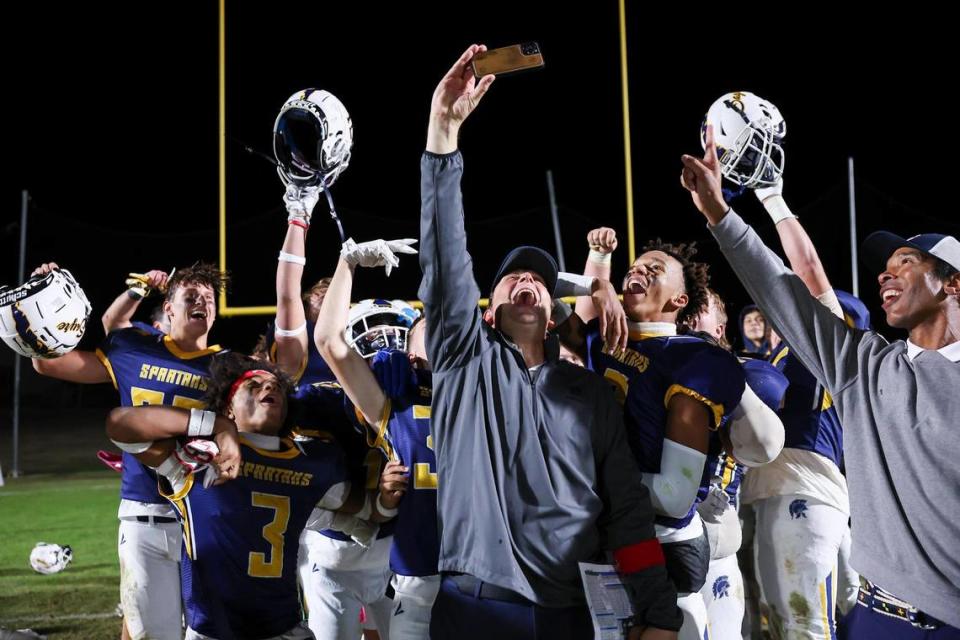 Sayre head coach Chad Pennington got out his phone to celebrate a 12-8 win over Eminence to help clinch the Spartans’ first football district championship at Sayre Athletic Complex on Friday.