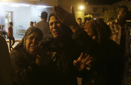 Women mourn after an Israeli air strike killed two Palestinian militants, at a hospital morgue in the central Gaza Strip July 6, 2014. REUTERS/Ibraheem Abu Mustafa