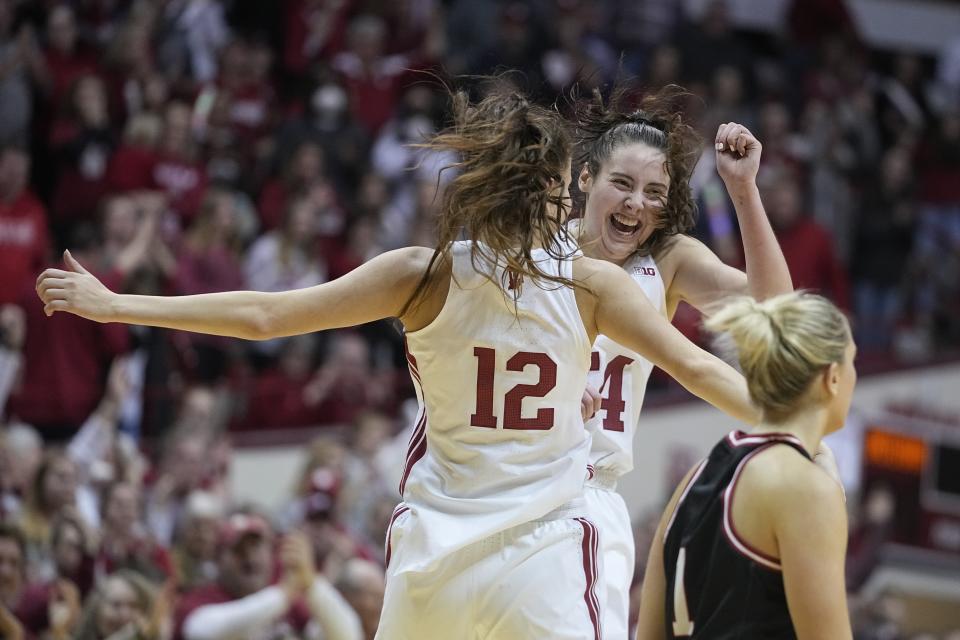 Indiana's Mackenzie Holmes (54) and Yarden Garzon (12) celebrate a win against Nebraska on Jan. 1, 2023, in Bloomington, Indiana. (AP Photo/Darron Cummings)