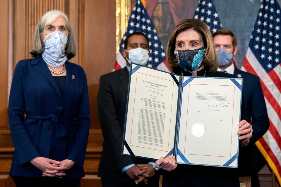 Nancy Pelosi displays a signed an article of impeachment against Donald Trump – making him the first president in history to be impeached twiceGetty Images