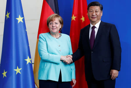 German Chancellor Angela Merkel and Chinese President Xi Jinping shake hands after the news conference at the Chancellery in Berlin, Germany, July 5, 2017. REUTERS/Fabrizio Bensch
