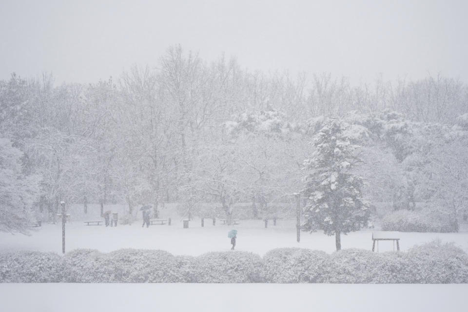 Visitors walk through the snow in Goyang, South Korea, Saturday, Dec. 30, 2023. South Korean Meteorological Administration issued a heavy snow advisory for some parts of the Korea peninsula. (AP Photo/Lee Jin-man)