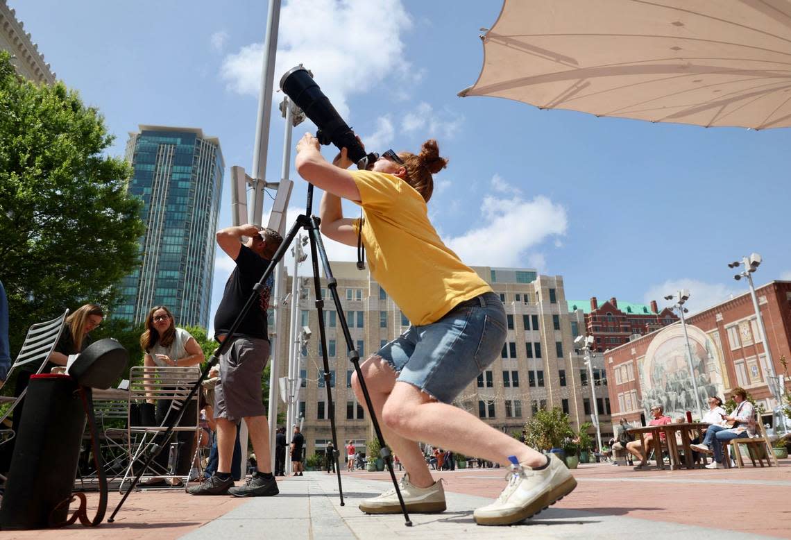 Garrett Minnie views the eclipse as it begins in Sundance Square in downtown Fort Worth on Monday, April 8, 2024. Amanda McCoy/amccoy@star-telegram.com