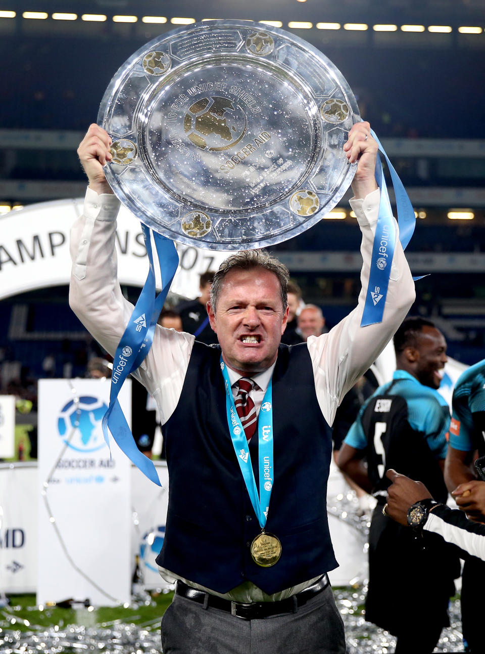 World Eleven Assistant Manager Piers Morgan celebrates with the trophy at the end of the Soccer Aid match at Stamford Bridge, London.