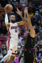 Miami Heat forward Caleb Martin (16) takes a shot against Cleveland Cavaliers guard Ricky Rubio (3) during the first half of an NBA basketball game, Wednesday, Dec. 1, 2021, in Miami. (AP Photo/Wilfredo Lee)