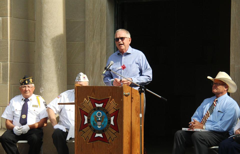 Master of Ceremonies Mick Peterson address the audience at the Memorial Day service at Southside Cemetery Monday.