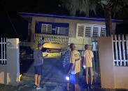 A collapsed building with car crushed underneath, following an earthquake in Yauco, Puerto Rico, Tuesday Jan. 7, 2020. All the occupants of the home are reported to be uninjured. A 6.5-magnitude earthquake struck Puerto Rico, the largest in a series of quakes in recent days, and caused heavy damage in some areas. (J. Miguel Santiago Twitter via AP)