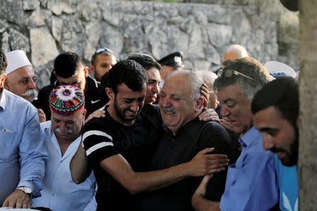 Family members of Israeli Druze police officer Kamil Shanan mourn during his funeral in the village of Hurfeish, Israel July 14 2017 REUTERS/Ammar Awad