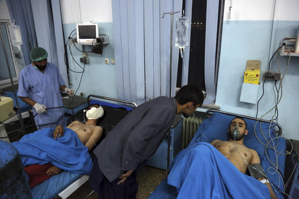 Injured men receive treatment at a hospital after a suicide bombing in Kabul, Afghanistan, Nov. 20, 2018. Afghan officials said the suicide bomber targeted a gathering of Muslim religious scholars. (AP Photo/Rahmat Gul)