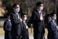 Japan's Prime Minister Fumio Kishida, left, and Defense Minister Nobuo Kishi review an honor guard at the Japan Ground Self-Defense Force Camp Asaka in Tokyo, Japan, Saturday, Nov. 27, 2021. (Kiyoshi Ota/Pool Photo via AP)