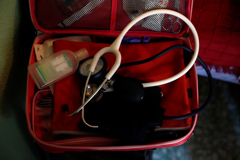 Hand sanitizer is seen in the medical kit of Comunidad de Madrid home care nurse Ana Arenal during a home visit in Madrid
