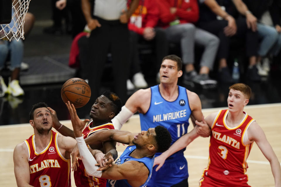 Milwaukee Bucks' Giannis Antetokounmpo (34), Atlanta Hawks' Danilo Gallinari (8) and Clint Capela (15) fight for the rebound during the second half of Game 3 of the NBA Eastern Conference basketball finals, Sunday, June 27, 2021, in Atlanta. (AP Photo/Brynn Anderson)