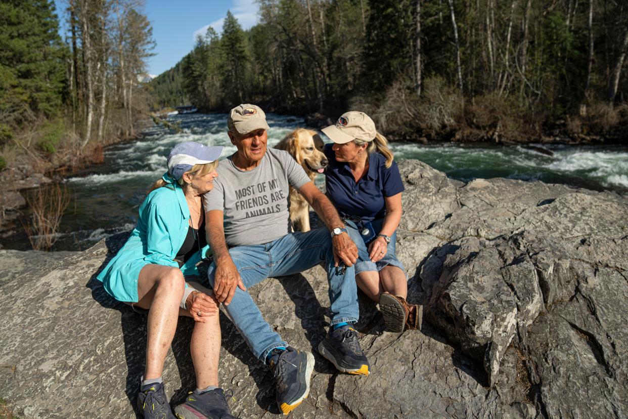 Jack Hanna sits with his wife, Suzi, his service dog, Brassy, and his daughter, Kathaleen, alongside the Swan River as they take their daily walk along the Bigfork Nature Trail near his Montana home on May 2.  As his battle with Alzheimer's continues, the public can share messages of support in a mailbox at the Columbus Zoo or through email, Columbus Zoo CEO Tom Schmid said Wednesday.