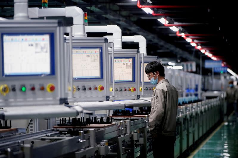 FILE PHOTO: An employee works on the production line of electric vehicle (EV) battery manufacturer Octillion in Hefei