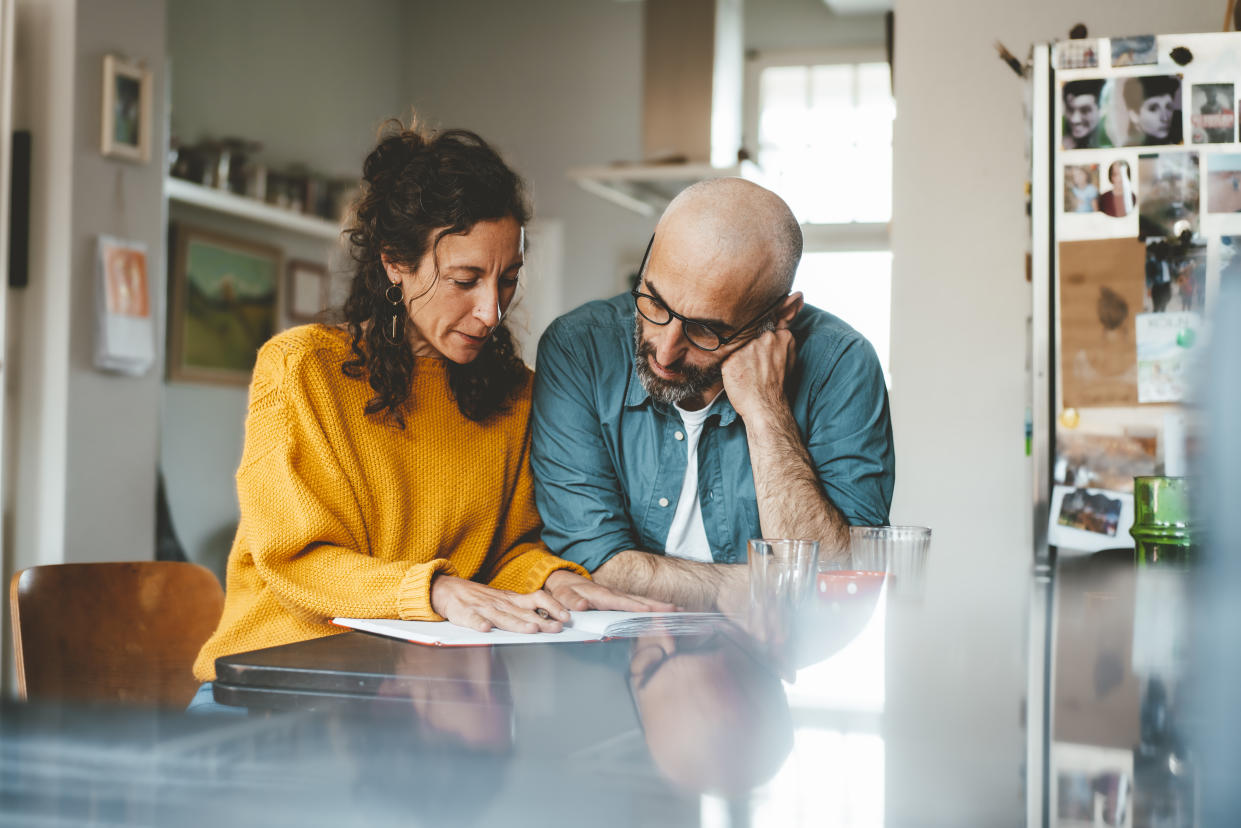 Man and woman preparing financial bills at home