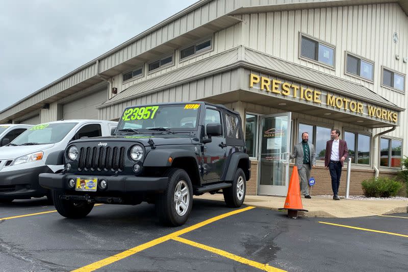 Alex Tovstanovsky, owner of used-car dealer Prestige Motor Works, checks on depleted inventory in Naperville