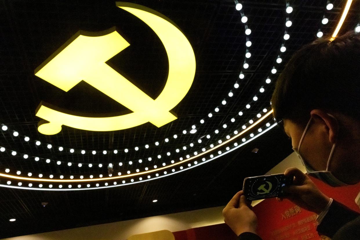 <p>File image: A man takes a picture of the emblem of Chinese Communist Party (CCP) at an exhibition marking the party's 100th founding anniversary in Beijing, China</p> (Reuters)