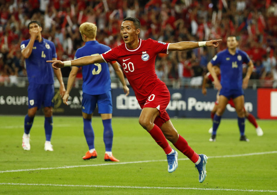 Singapore's Shawal Anuar celebrates scoring their first goal against Thailand in their 2026 World Cup qualifying match at Singapore National Stadium.