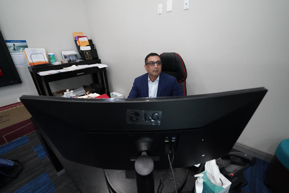 Vimal Patel president of Q Hotels, poses for a photograph at his Holiday Inn Express Hotel in LaPlace, La., Wednesday, June 23, 2021. (AP Photo/Gerald Herbert)