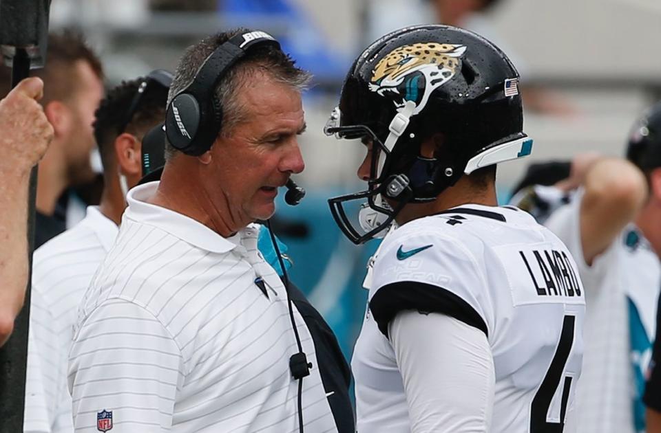 Jacksonville Jaguars head coach Urban Meyer, left, talks with Josh Lambo after Lambo missed his second field goal during a game against the Denver Broncos in September in Jacksonville. (STEPHEN B. MORTON | AP)