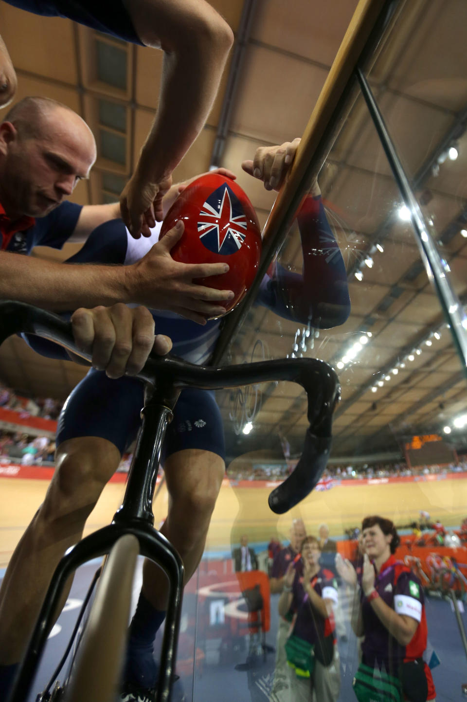 LONDON, ENGLAND - AUGUST 02: Sir Chris Hoy of Great Britain is aided with removing his helmet after setting a new world record in the Men's Team Sprint Track Cycling final on Day 6 of the London 2012 Olympic Games at Velodrome on August 2, 2012 in London, England. (Photo by Bryn Lennon/Getty Images)