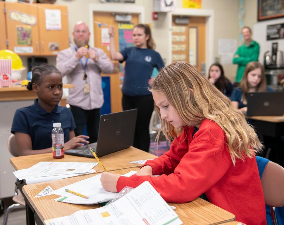 Cordova Park fifth-grader Salya Cushing takes notes as her teacher, Andy Roberts, demonstrates a scientific concept during class on Thursday, Nov. 16, 2023. Cordova Park is one of two Escambia County Public Schools that will add sixth-grade classes to its offering in the 2024-25 school year.