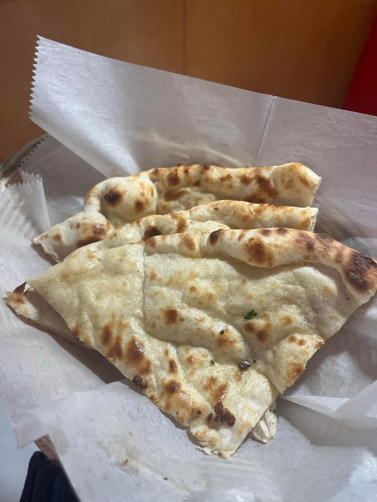 Naan is leavened white bread baked in a tandoor at The Spice Delight in Munroe Falls.