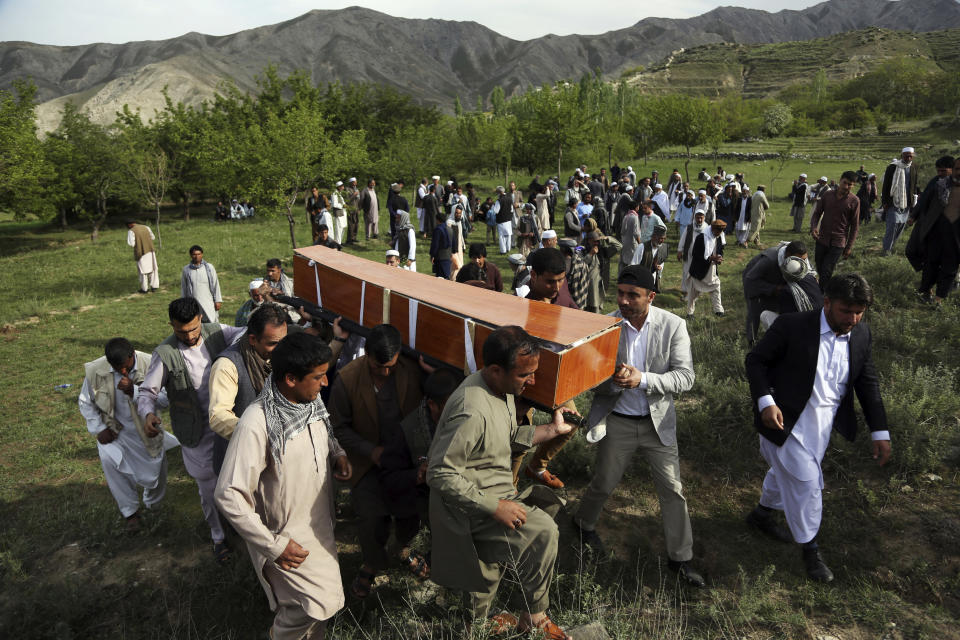 FILE - In this April 30, 2018 file photo, relatives, colleagues and friends of AFP chief photographer, Shah Marai, who was killed that day in a second suicide attack, carry his coffin in his village, Guldara, a district of Kabul province, Afghanistan. A New York-based organization dedicated to the safety of journalists says the deadliest country for journalists this year has been Afghanistan, where 13 journalists were killed. (AP Photo/Rahmat Gul, File)