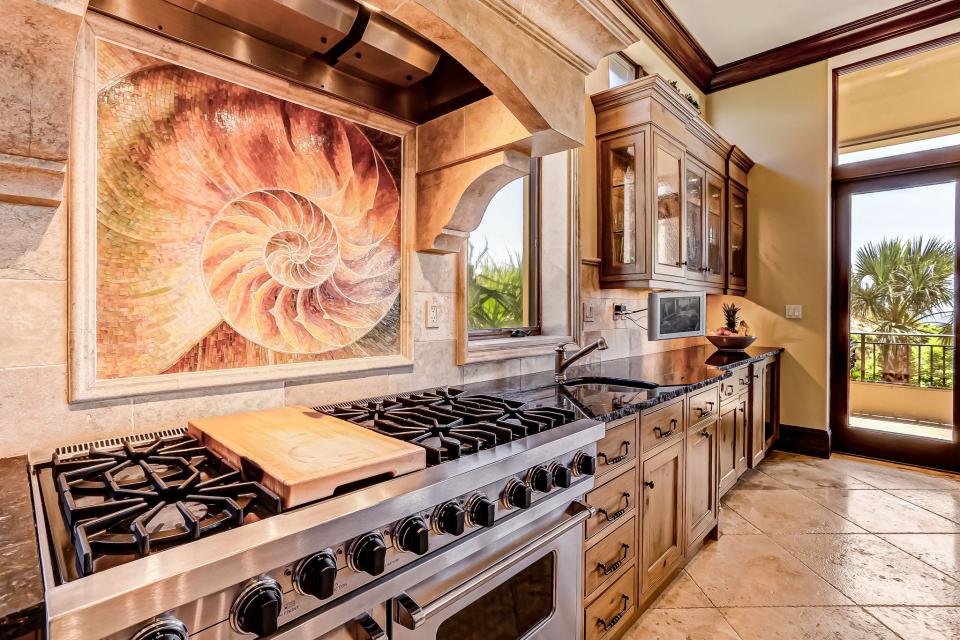 The nautilus motif, as shown on this unique mosaic backsplash, is a recurring theme throughout the home, meant to emulate the growth of family and legacy of the home.
