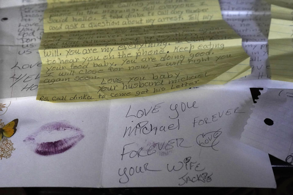 Letters written by Michael Williams to his wife, Jacqueline Anderson, and a card she sent him and sealed with a lipstick kiss are just a few samples of the correspondence between the two in their South Side Chicago home Monday, Aug. 2, 2021. Williams sat behind bars at Cook County Jail for nearly a year before a judge dismissed the murder case against him in July at the request of prosecutors, who said they had insufficient evidence. (AP Photo/Charles Rex Arbogast)