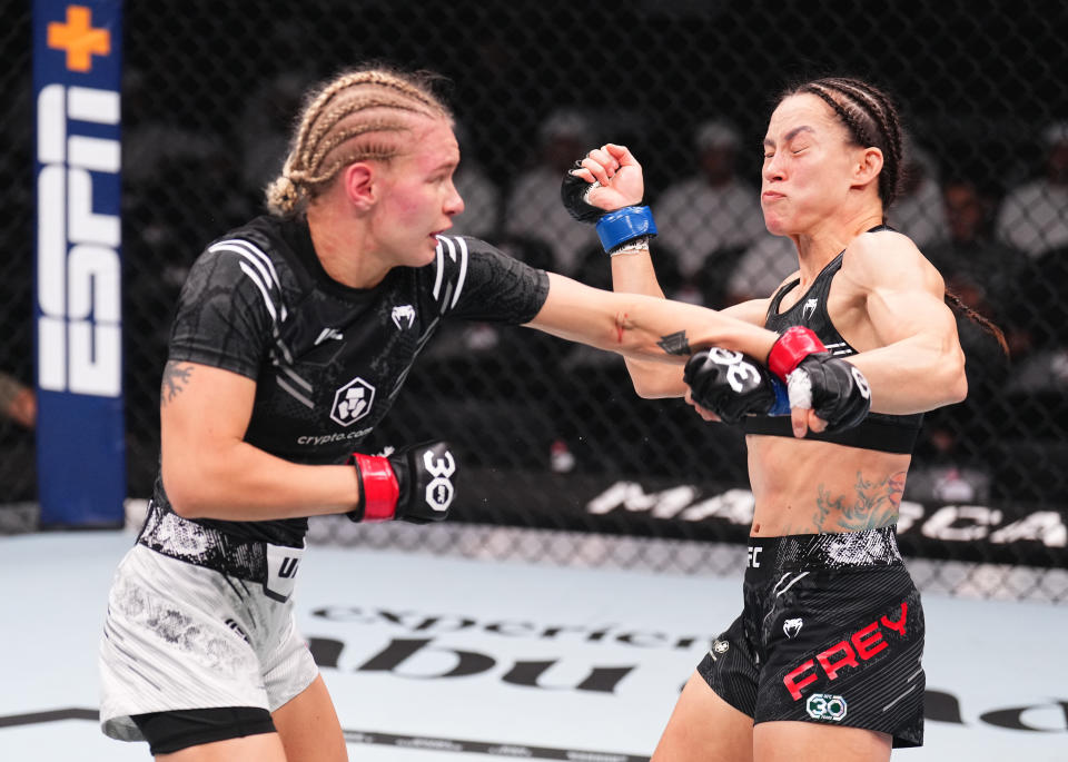 ABU DHABI, UNITED ARAB EMIRATES - OCTOBER 21: (L-R) Viktoriia Dudakova of Russia punches Jinh Yu Frey in a strawweight fight during the UFC 294 event at Etihad Arena on October 21, 2023 in Abu Dhabi, United Arab Emirates. (Photo by Chris Unger/Zuffa LLC via Getty Images)