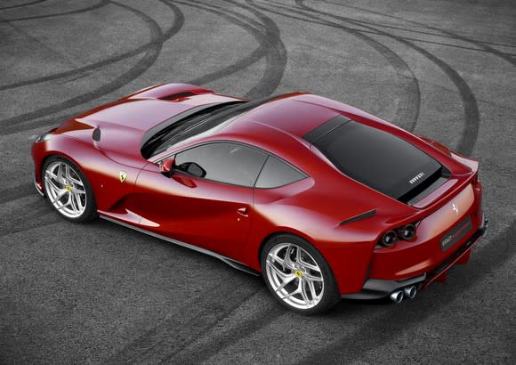 A red Ferrari 812 Superfast, a two-seat sports car, viewed from above.