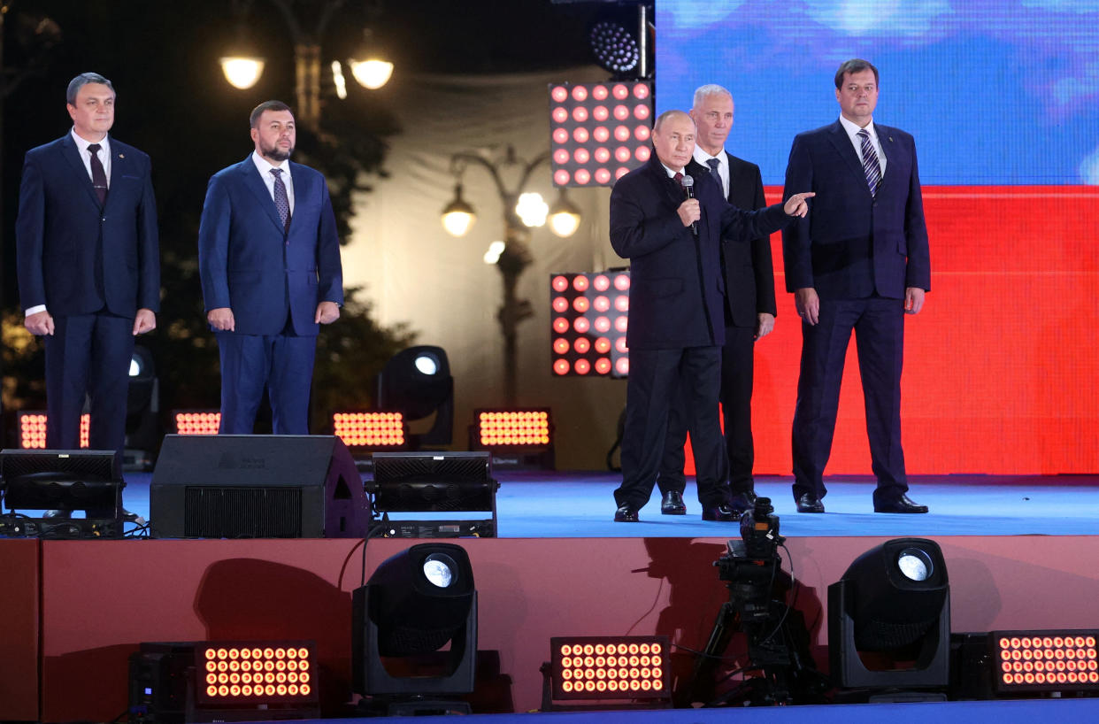 Russian President Vladimir Putin and Denis Pushilin, Leonid Pasechnik, Vladimir Saldo, Yevgeny Balitsky, who are the Russian-installed leaders in Ukraine's Donetsk, Luhansk, Kherson and Zaporizhzhia regions, attend a concert marking the declared annexation of the Russian-controlled territories of four Ukraine's Donetsk, Luhansk, Kherson and Zaporizhzhia regions, after holding what Russian authorities called referendums in the occupied areas of Ukraine that were condemned by Kyiv and governments worldwide, in Red Square in central Moscow, Russia, September 30, 2022. Sputnik/Sergei Karpukhin/Pool via REUTERS ATTENTION EDITORS - THIS IMAGE WAS PROVIDED BY A THIRD PARTY.
