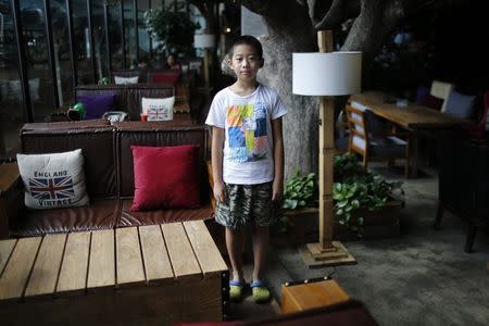 Only child Qian Dingheng, who was born in 2005, poses for a photograph in Shanghai August 30, 2014. REUTERS/Carlos Barria