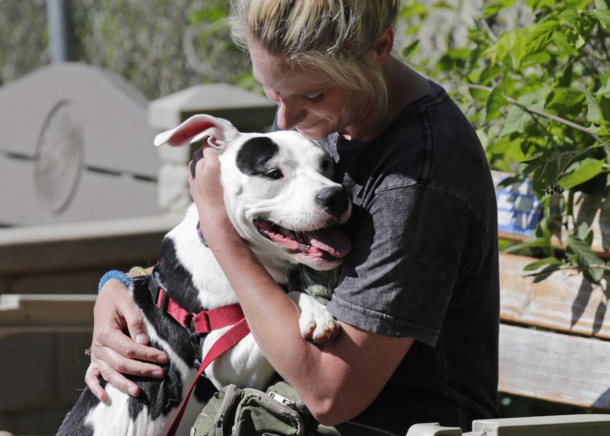 FILE - Employee Jenny Mosman spends time with Meela on Thursday, June 2, 2022, at the Oshkosh Area Humane Society.