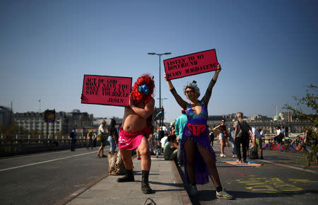 Climate change activists hold placards during the Extinction Rebellion protest in London, Britain April 21, 2019. REUTERS/Hannah McKay