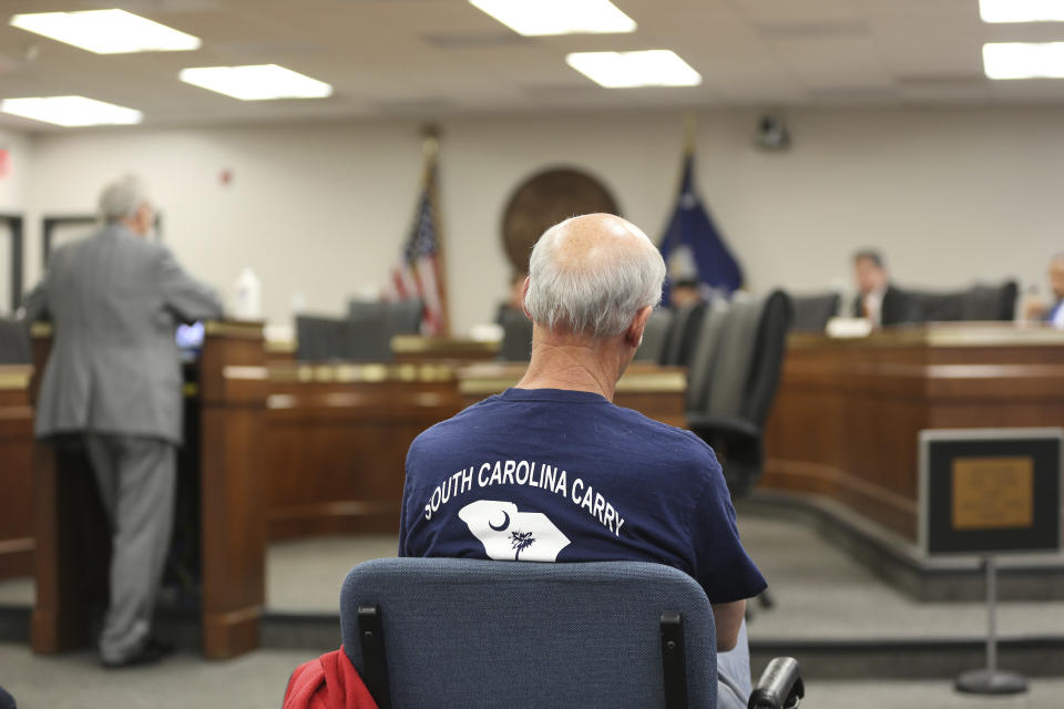 A supporter of a bill to allow people in South Carolina who already have concealed weapons permits to carry their guns in the open listens to a Senate subcommittee hearing on the proposal on Tuesday, April 27, 2021, in Columbia, S.C. The bill doesn't appear to have time to pass this session. (AP Photo/Jeffrey Collins)