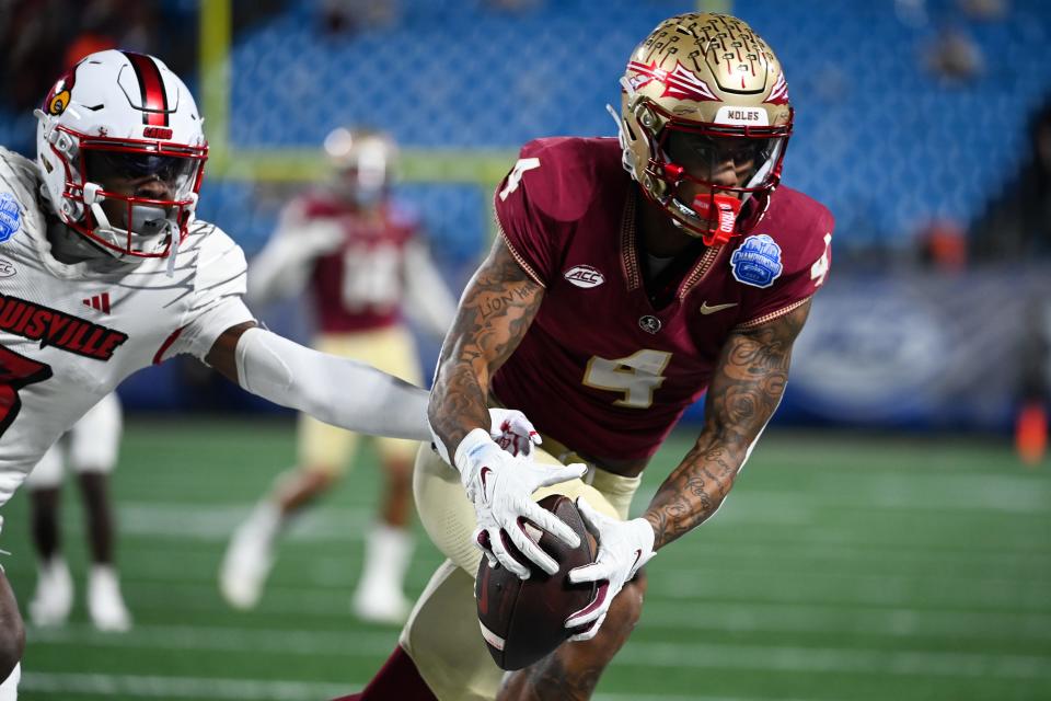 Florida State Seminoles wide receiver Keon Coleman (4) makes a catch against the Louisville Cardinals in the second quarter at Bank of America Stadium in Charlotte, N.C., on Dec. 2, 2023.