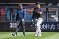 Cleveland Indians' Harold Ramirez, right, walks off the field after crashing into the wall while attempting to catch a home run by New York Yankees' Gio Urshela in the third inning of a baseball game Sunday, Sept. 19, 2021, in New York. (AP Photo/Eduardo Munoz Alvarez)