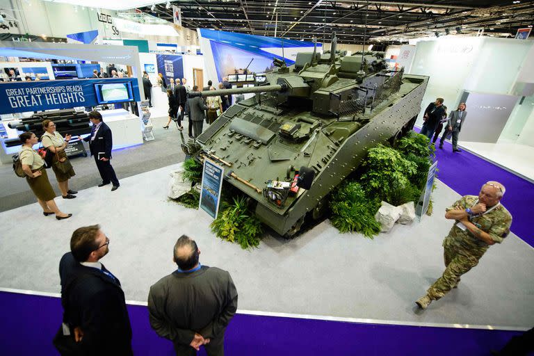 Embargoed until March 13, 2022 - 23:01 GMT / (FILES) This file photo taken on September 15, 2015 shows visitors looking at a modified Warrior tracked armoured vehicle displayed inside the ExCeL centre in London during the Defence and Security Equipment International (DSEI) arms fair. - Europe saw the world's biggest increase in arms imports in the past five years and the trend is set to accelerate following recent rearmament commitments after Russia's invasion of Ukraine, researchers said on March 14, 2022. While arms exports declined globally by 4.6 percent in 2017-2021 compared to the preceding five years, Europe posted a 19-percent increase, according to a study published by the Stockholm International Peace Research Institute (SIPRI). (Photo by LEON NEAL / AFP
