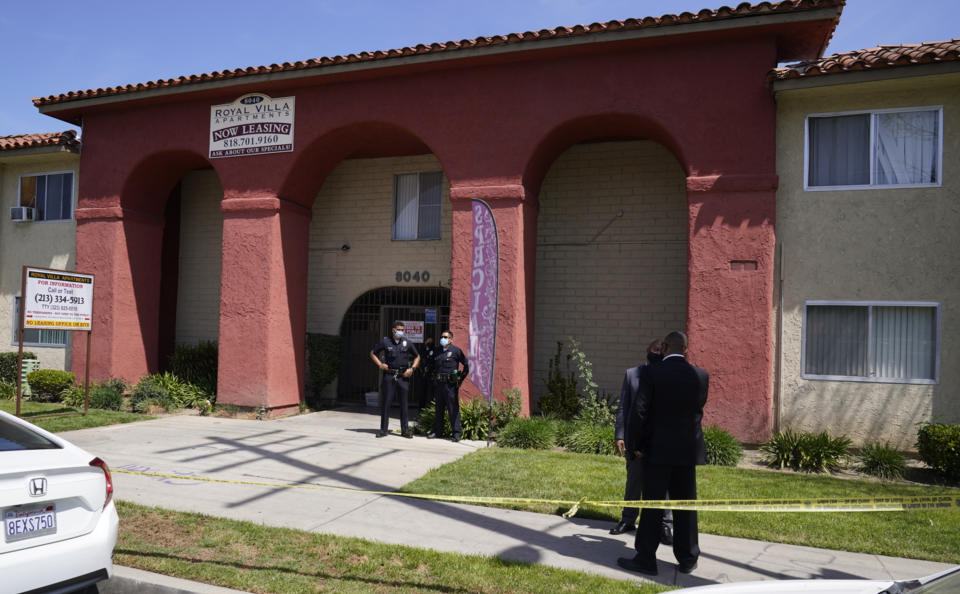 Los Angeles Police investigate the scene of a crime at an apartment complex in Reseda, Calif., Saturday, April 10, 2021. A woman discovered her three grandchildren, all under the age of 5, slain inside a Los Angeles apartment Saturday morning and their mother gone, police said. The mother of three children — all under the age of 5 — found slain inside a Los Angeles apartment Saturday morning has been arrested, police said. (AP Photo/Damian Dovarganes)