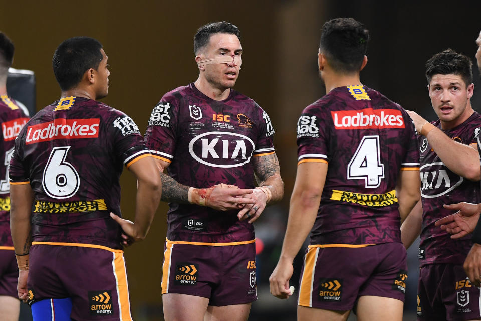 Darius Boyd of the Broncos talks to his team mates.