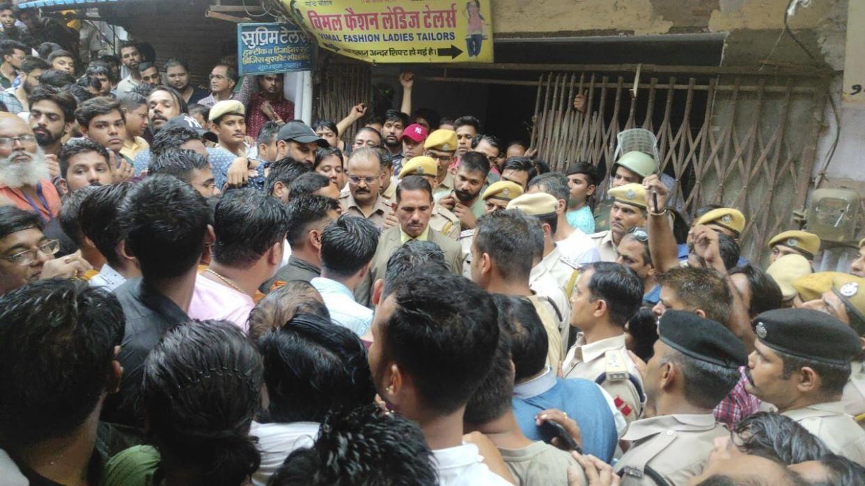 A crowd gathers outside the shop of a tailor who was killed, as police investigate in Udaipur, India, Tuesday, June 28, 2022. Mobile internet services and large gatherings have been restricted in India’s western Udaipur city, a day after police arrested two Muslim men accused of killing a Hindu tailor in a suspected religious attack. The Hindu man, Kanhaiya Lal, was stabbed multiple times inside his tailoring shop Tuesday by two cleaver-wielding men who also filmed the attack, news agency Press Trust of India reported. (AP Photo).