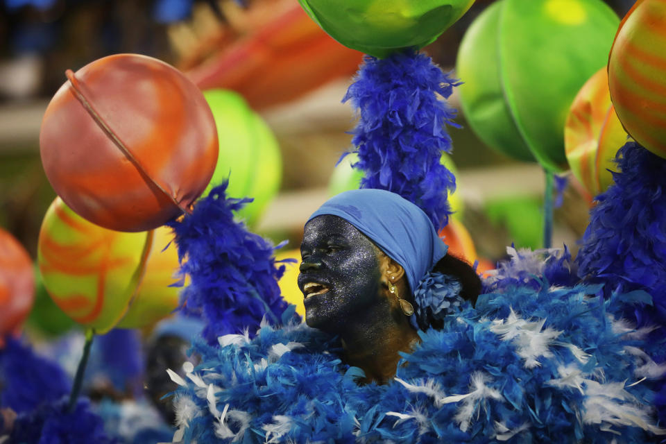 A performer from the Unidos de Vila Isabel samba school parades during Carnival celebrations at the Sambadrome in Rio de Janeiro, Tuesday, Feb. 12, 2013. Rio de Janeiro's samba schools vied for the title of the year's best in an over-the-top, all-night-long Carnival parade at the city's iconic Sambadrome. (AP Photo/Silvia Izquierdo)