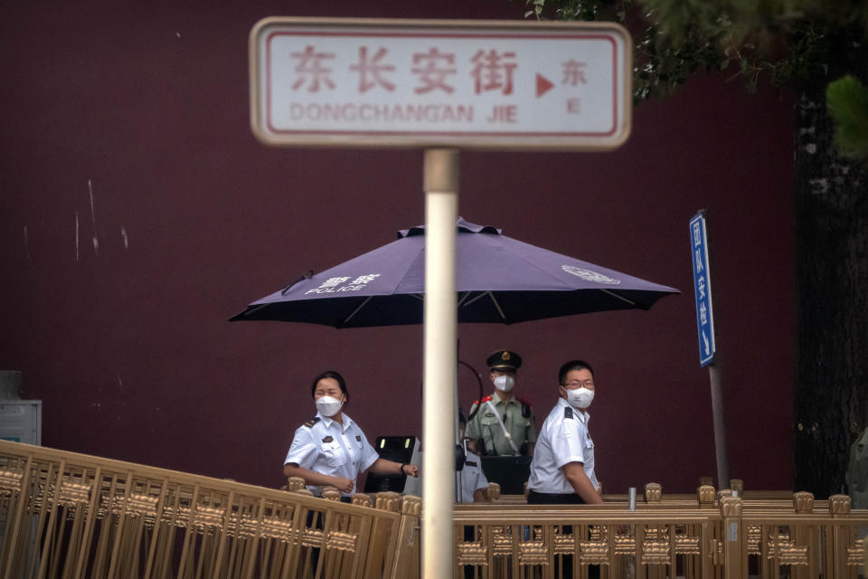 Security officers wearing face masks stand at a checkpoint near Tiananmen Square in Beijing, Saturday, June 4, 2022. Saturday marks the anniversary of China’s bloody 1989 crackdown on pro-democracy protests at Beijing’s Tiananmen Square. (AP Photo/Mark Schiefelbein)
