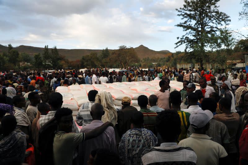FILE PHOTO: People stand in line to receive food donations, at the Tsehaye primary school in Shire